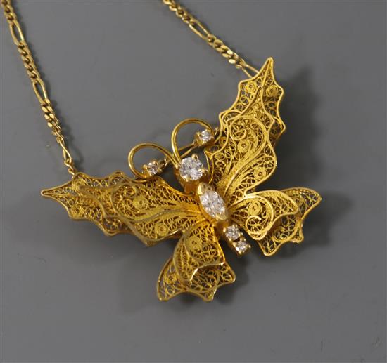 An 18ct gold and diamond set filligree butterfly pendant on chain, from The House of Igor Carl Faberge, Geneva, pendant width 39mm.